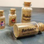 uv dtf sample on sand bottles